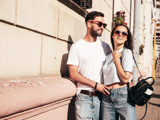 Smiling beautiful woman and her handsome boyfriend. Woman in casual summer jeans clothes. Happy...