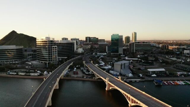 Drone shot over the Tempe Bridge in Arizona at sunset.