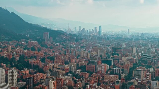 Wide cityscape of Bogot&aacute; framed by majestic mountains, showcasing urban life and natural beauty.