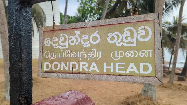 Sign for Dondra Head Lighthouse at southernmost point of Sri Lanka in Tamil, Sinhala, and English language