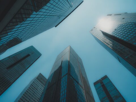 Tall glass buildings against blue sky skyscrapers modern architecture - Powered by Adobe
