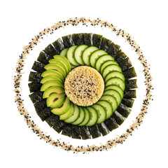 A visually appealing circular food arrangement featuring fresh seaweed, sliced cucumber, avocado, and couscous, garnished with sesame seeds.