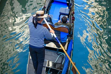 Fototapete Rund Gondeln Tourists taking gondola, the traditional Venetian boat, on canal in Venice, Italy  © momo11353