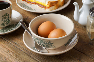 Traditional Kopitiam Style: Two Half-Boiled Eggs in a Bowl for Malaysian Breakfast and Local Food Culture