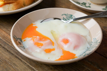 Traditional Kopitiam: Two Half-Boiled Eggs Served on a Small Plate for Malaysian Breakfast and Local Food Culture