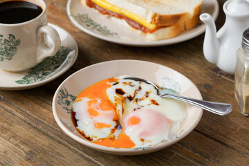 Traditional Kopitiam: Two Half-Boiled Eggs Served on a Small Plate for Malaysian Breakfast and Local Food Culture