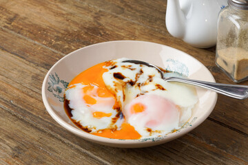 Traditional Kopitiam: Two Half-Boiled Eggs Served on a Small Plate for Malaysian Breakfast and Local Food Culture