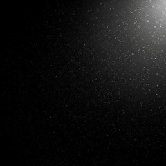Fototapeta premium Abstract black background with scattered light particles. Particles suspended in the air with a light source creating a glowing effect.