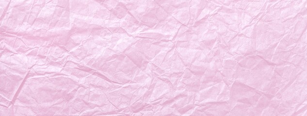 Crumpled pastel pink paper background, macro. Texture of wrinkled light soft rose backdrop wallpaper