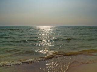 Tranquil Sea with Sunlight Reflection at Sunset