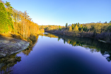 View of the Ronsdorf Dam and the surrounding landscape in autumn. Nature at the lake near Wuppertal. Saalbach Dam.
