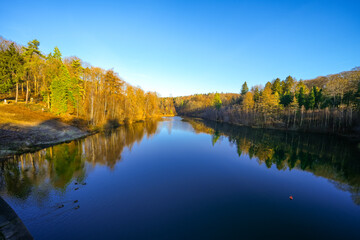 View of the Ronsdorf Dam and the surrounding landscape in autumn. Nature at the lake near Wuppertal. Saalbach Dam.
