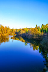 View of the Ronsdorf Dam and the surrounding landscape in autumn. Nature at the lake near Wuppertal. Saalbach Dam.
