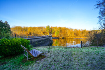 Fototapeta premium View of the Ronsdorf Dam and the surrounding landscape in autumn. Nature at the lake near Wuppertal. Saalbach Dam. 