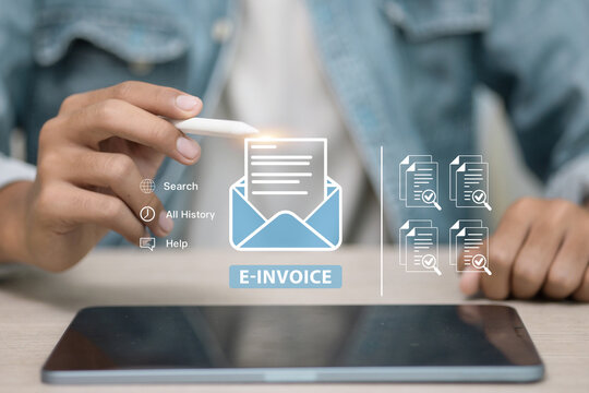 Person holding stylus pointing at e‑invoice interface on tablet, digital billing concept