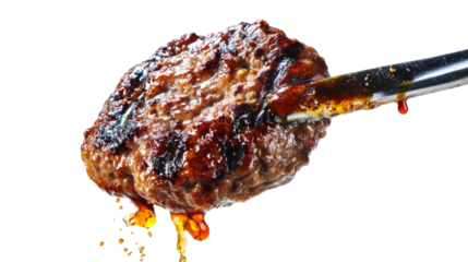 Juicy burger patty held in tongs, dripping with grilled fat, sizzling on white backdrop