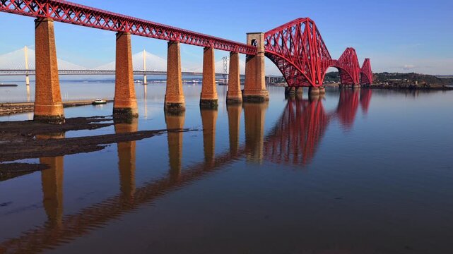 Aerial reveal of the three Firth of Forth Bridges in Edinburgh - Scotland. 