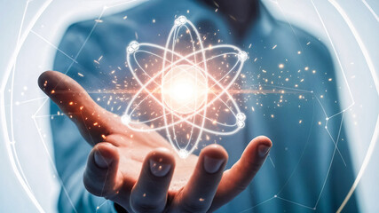 未来の科学と技術を示す手のひらの輝く原子