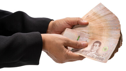 Hand holding a stack of Thai baht banknotes isolated on white with clipping path , concept of payment, corruption, or financial transaction