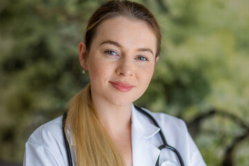 Confident female healthcare professional with a stethoscope outdoors