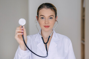 Female doctor holding a stethoscope focusing on healthcare and professionalism