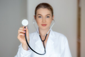Professional doctor holding a stethoscope and focusing on patient care