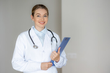 doctor wearing a white lab coat and holding a clipboard