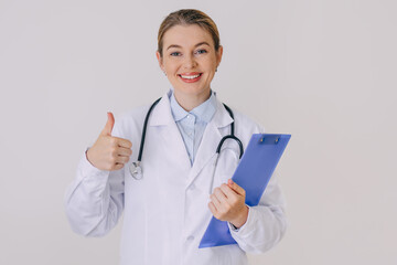 Smiling female doctor holding a clipboard and showing a thumbs-up gesture
