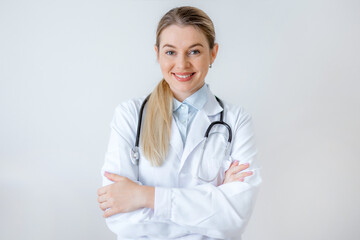 Smiling professional doctor with a stethoscope posing with arms crossed