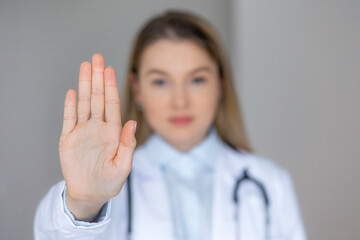 Doctor making a stop gesture, emphasizing caution or boundaries