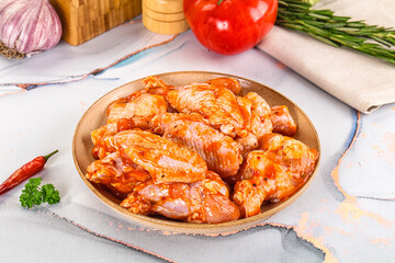 Raw marinated uncooked chicken wings