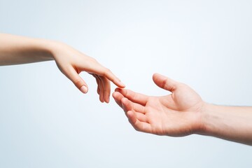 Two human hands reaching toward each other with fingers almost touching on a soft light background, symbolizing connection and trust.