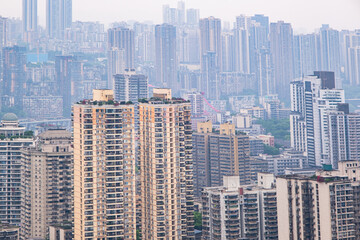 Fototapeta premium View from the rooftop of tall buildings in the Chongqing city, Chongqing is a giant city in southwestern China, founded at the confluence of the Yangtze and Jialingjiang rivers, China