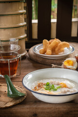 Rice porridge or pork congee for breakfast, boiled eggs, fried dough sticks, traditional coffee, soft-boiled eggs
