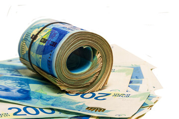 Money. New Israeli shekel. 200 shekel banknotes. Rolled banknotes are on banknotes lying on a transparent background.