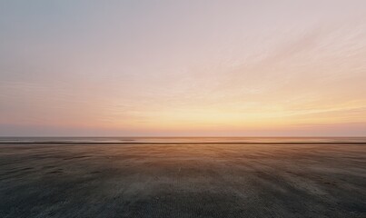 Empty paved space at sunset
