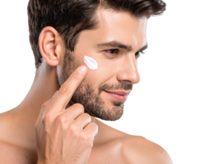 A man applies white cream to his cheek, showcasing a skincare routine against a black background.