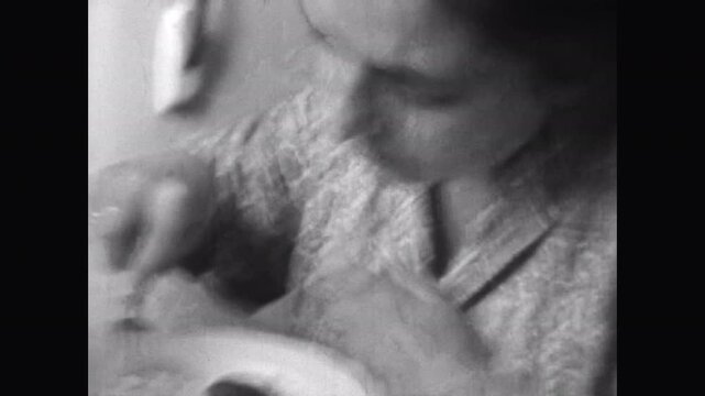 Close up, woman portrait eating homemade soviet food. Hungry adult woman eats dinner quickly in home kitchen. Good healthy appetite. Nutrition lunch indoor. Archival retro film. Archival vintage 1960s