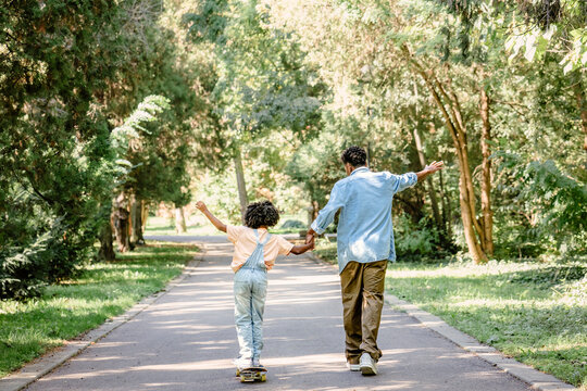 Father and daughter enjoying leisure time together in park