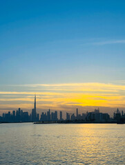 Obraz premium Dubai Creek Harbor View of Burj Khalifa and Sunset