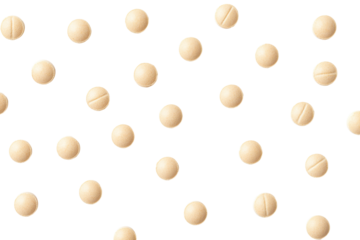 Scattered round beige pills with a dividing line isolated on transparent background.