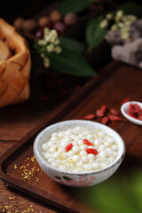 Small glutinous rice balls of different colors, mini balls made of flour, served with fruits or wolfberries