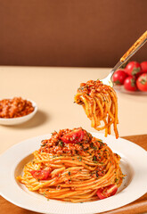 Pasta and pepper on table indoors, brown background