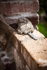 Fototapeta premium closeup of building a brickwall with historical looking bricks