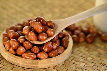 Fried peanuts wrapped with salt in wooden bowl, detail shot