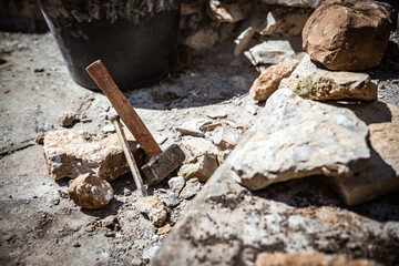 a man builds or renovates a historical looking wall with old bricks
