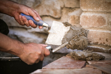 a man grouts and builds a natural stone floor