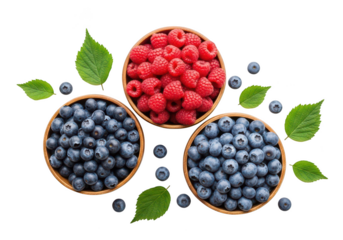 Three wooden bowls filled with fresh raspberries and blueberries with green leaves fruit raspberry