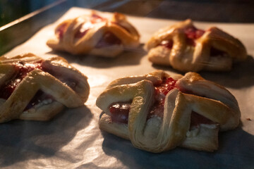Pastry with raspberry jam from puff pastry. Dessert from dough. Delicious and high-calorie food