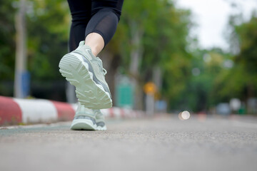 Fototapeta premium Close-up of Runner feet running at the road